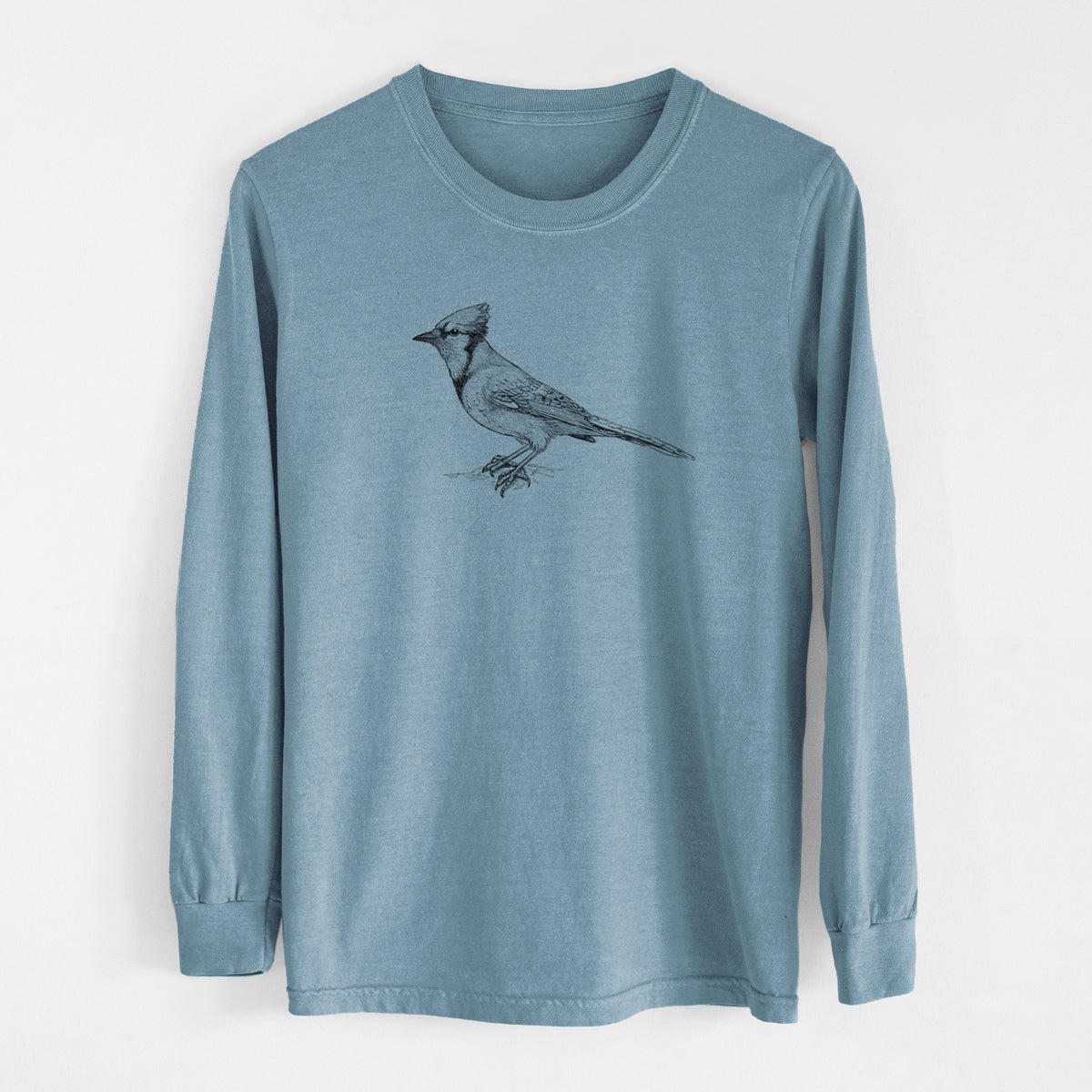 Steel blue Comfort Colors long sleeve shirt laid flat, printed with a detailed black ink sketch of a blue jay perched with its crest raised.