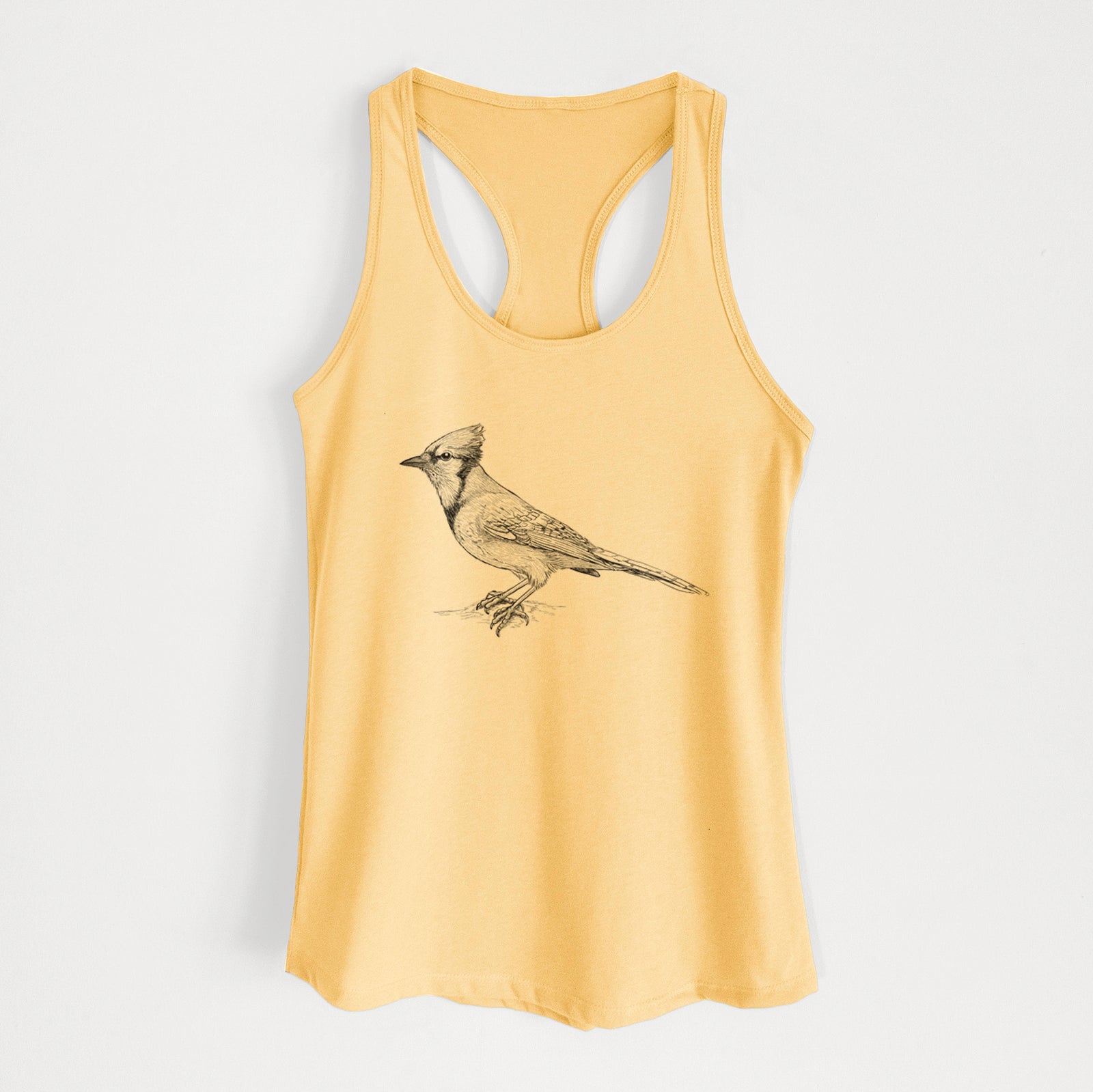 Banana cream women's racerback tank top laid flat, printed with a detailed black ink sketch of a blue jay perched with its crest raised.