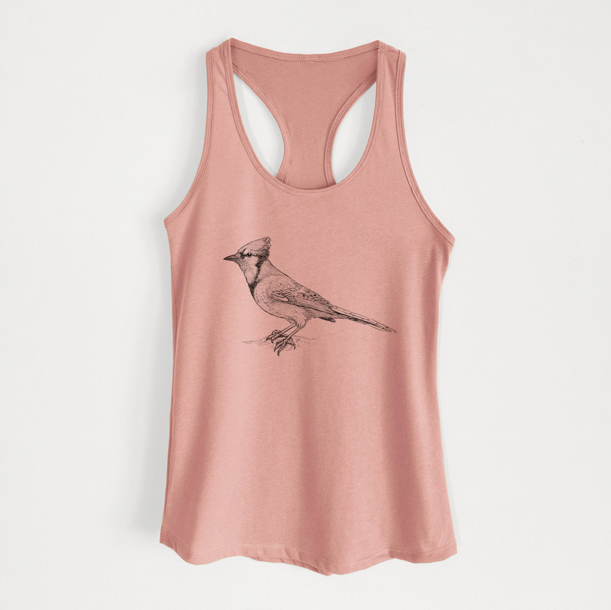 Desert pink women's racerback tank top laid flat, printed with a detailed black ink sketch of a blue jay perched with its crest raised.