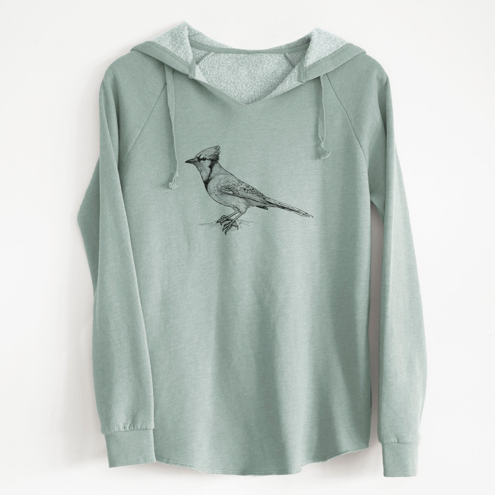 Sage green women's Cali Wave hooded sweatshirt laid flat, printed with a detailed black ink sketch of a blue jay perched with its crest raised.