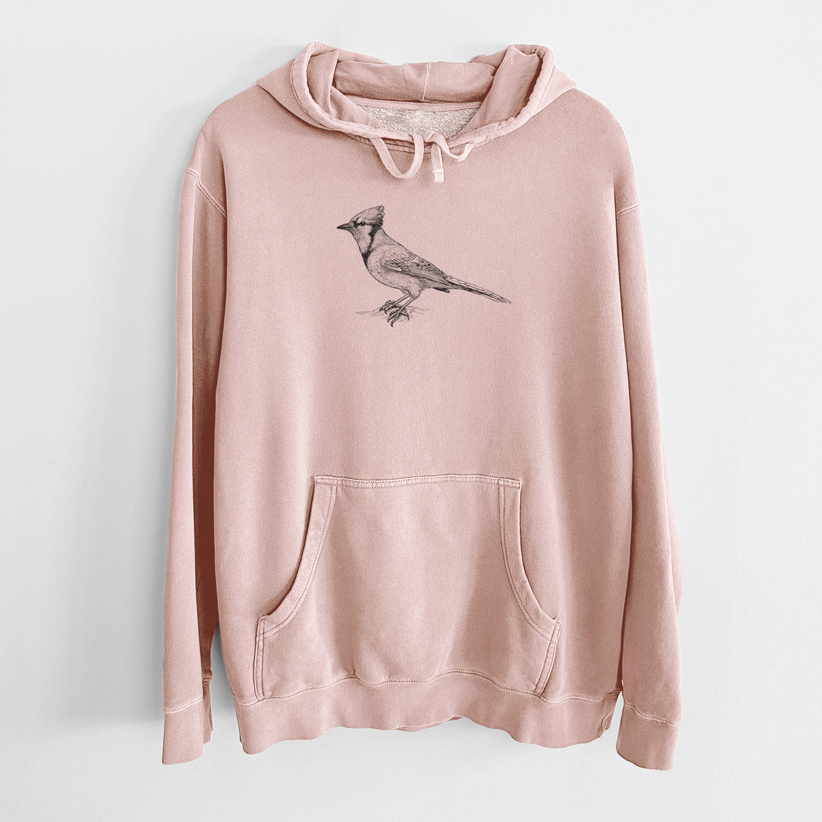 Dusty pink pigment dyed hoodie laid flat, printed with a detailed black ink sketch of a blue jay perched with its crest raised.