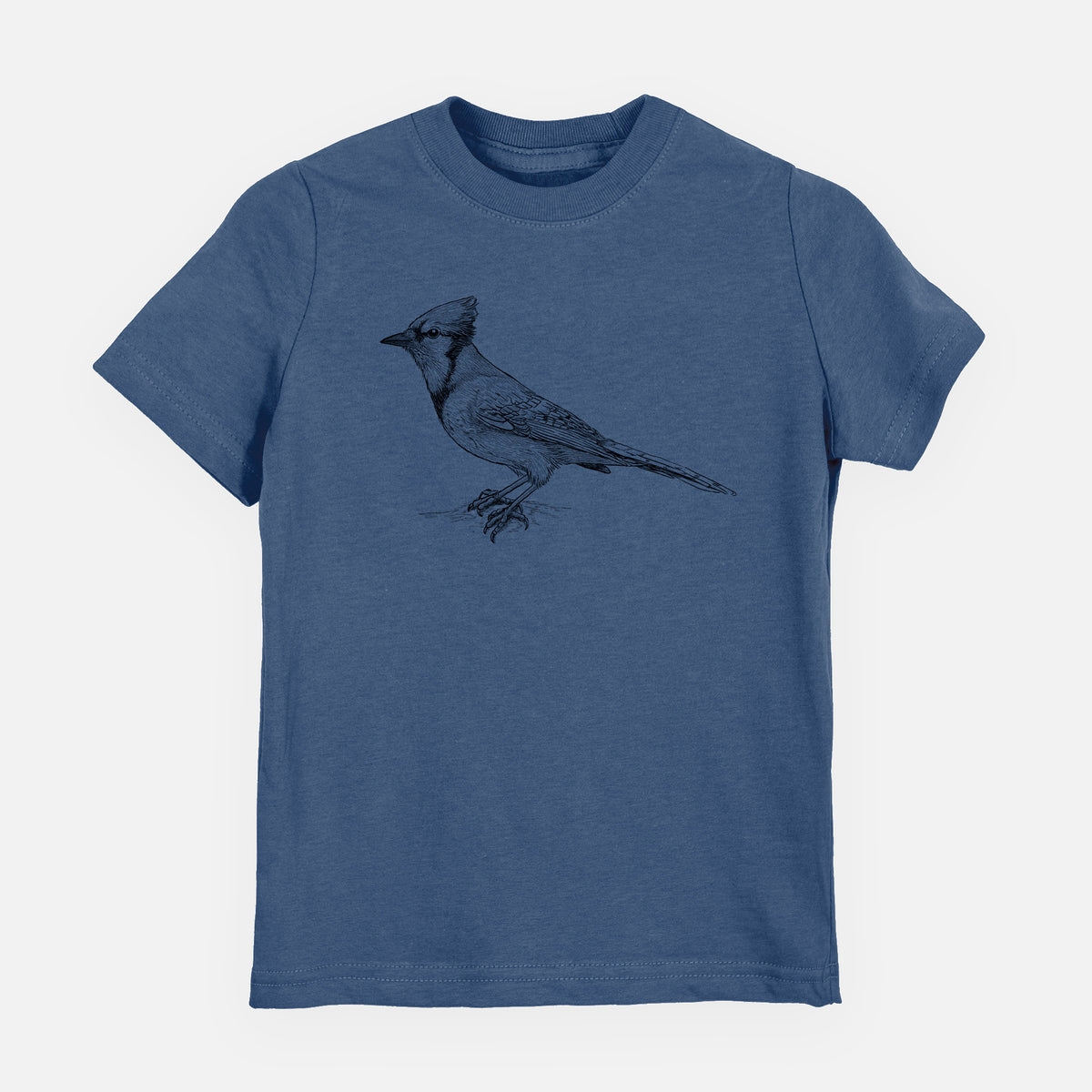 Indigo blue youth t-shirt laid flat, printed with a detailed black ink sketch of a blue jay perched with its crest raised.