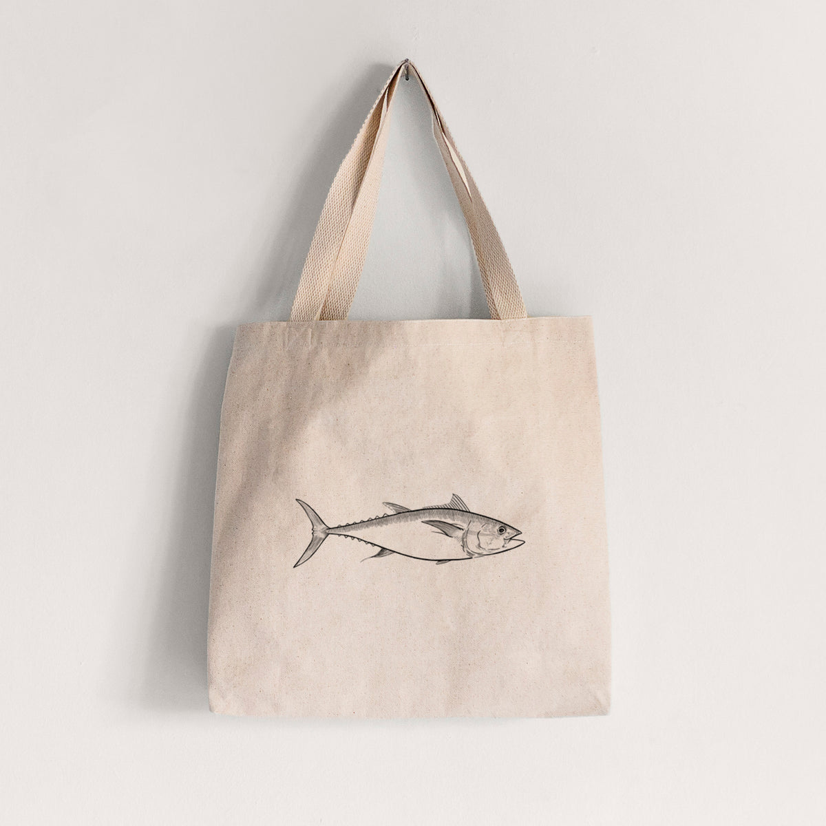 Natural canvas tote bag printed with a black ink line drawing of a bluefin tuna swimming.