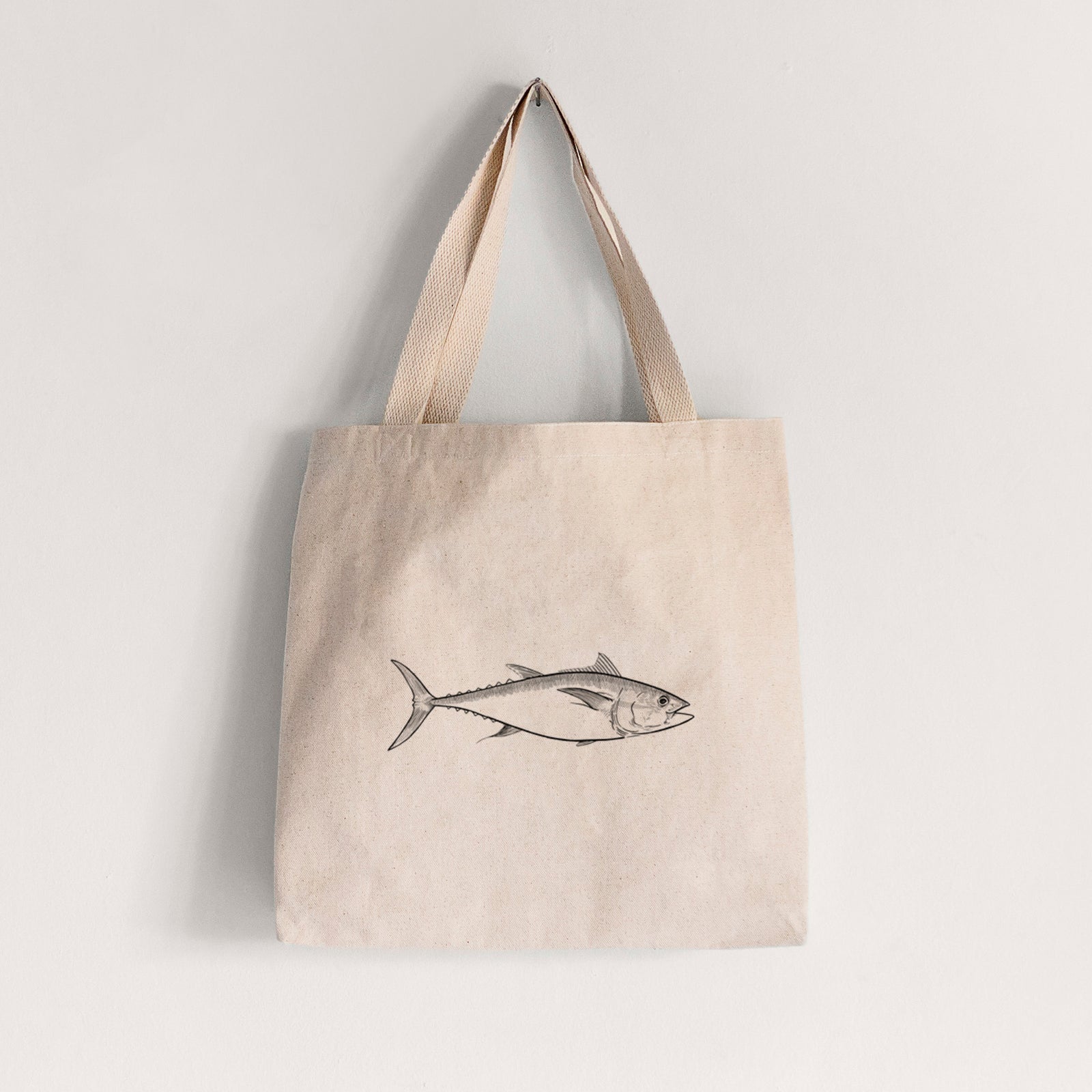 Natural canvas tote bag printed with a black ink line drawing of a bluefin tuna swimming.