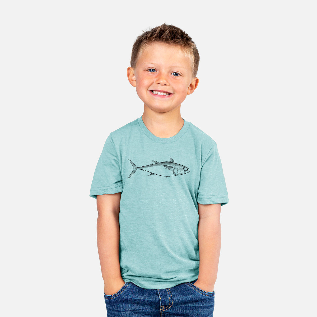 Smiling boy wearing a youth t-shirt printed with a black ink line drawing of a bluefin tuna swimming.