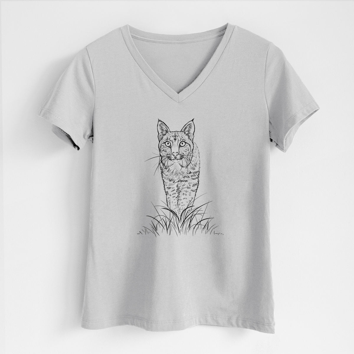 Lunar grey women's relaxed fit cotton V-neck t-shirt laid flat, printed with a black ink illustration of a bobcat standing in tall grass, facing forward.