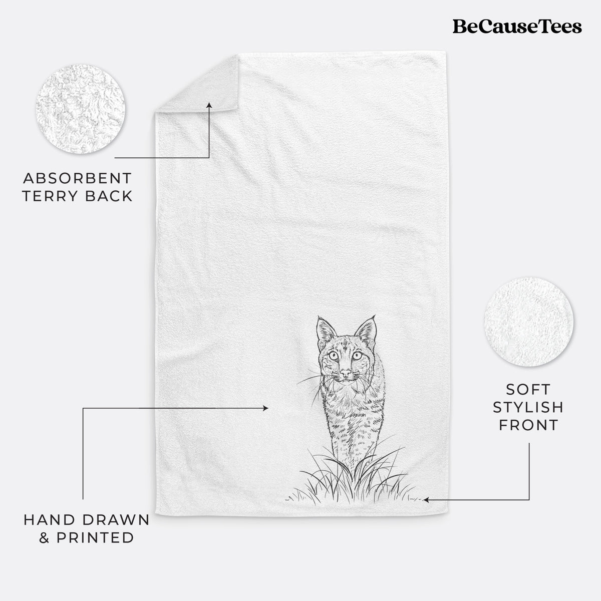 White hand towel printed with a black ink illustration of a bobcat standing in tall grass, facing forward.