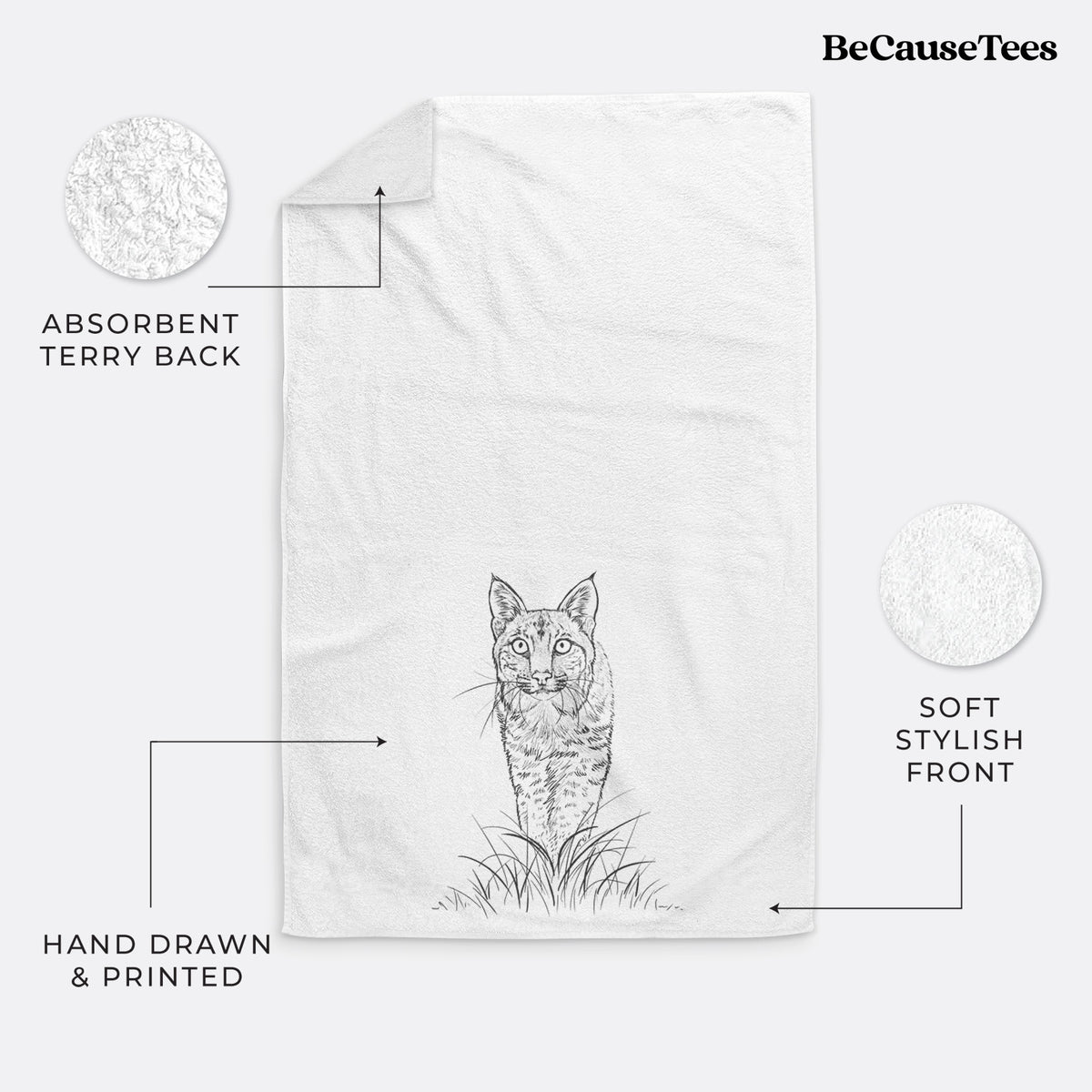 White hand towel printed with a black ink illustration of a bobcat standing in tall grass, facing forward.