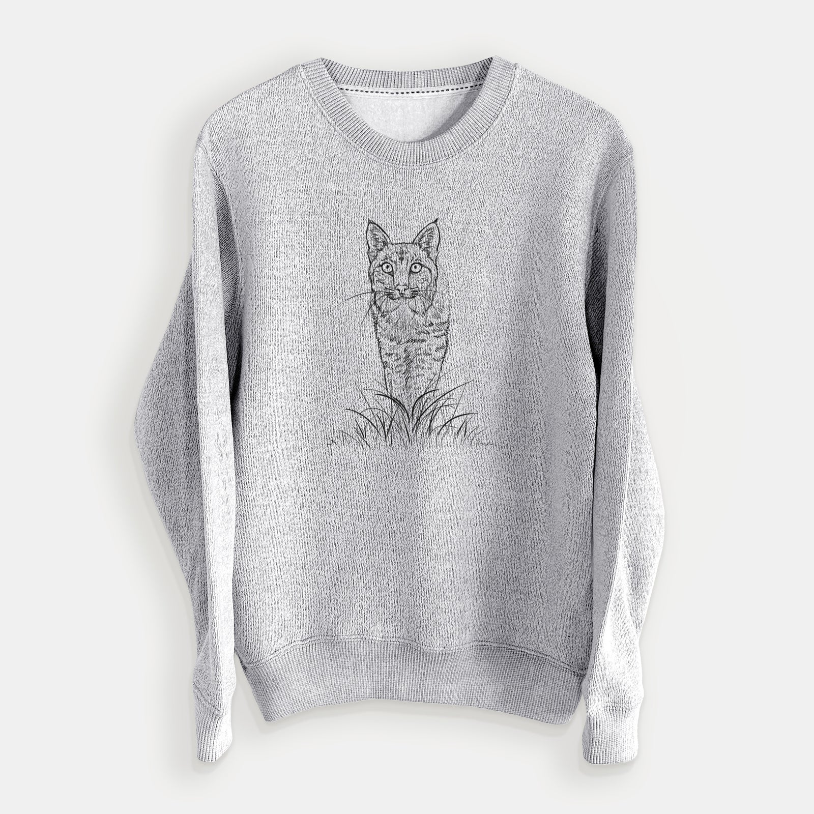 Salt and pepper knit sweatshirt laid flat, printed with a black ink illustration of a bobcat standing in tall grass, facing forward.