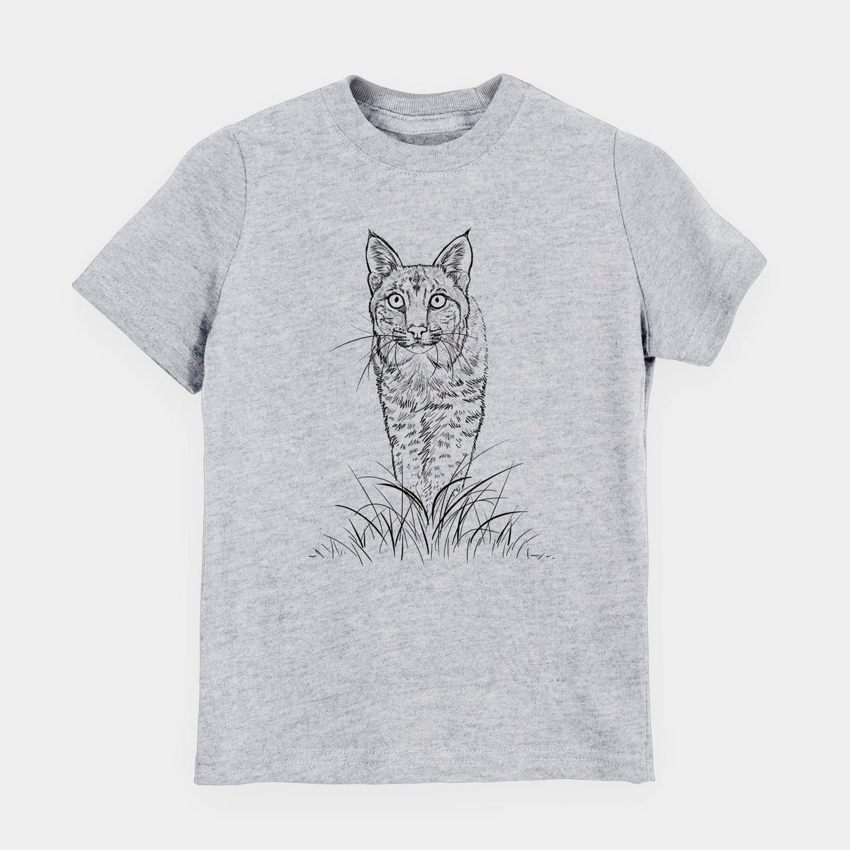 Heather grey youth t-shirt laid flat, printed with a black ink illustration of a bobcat standing in tall grass, facing forward.