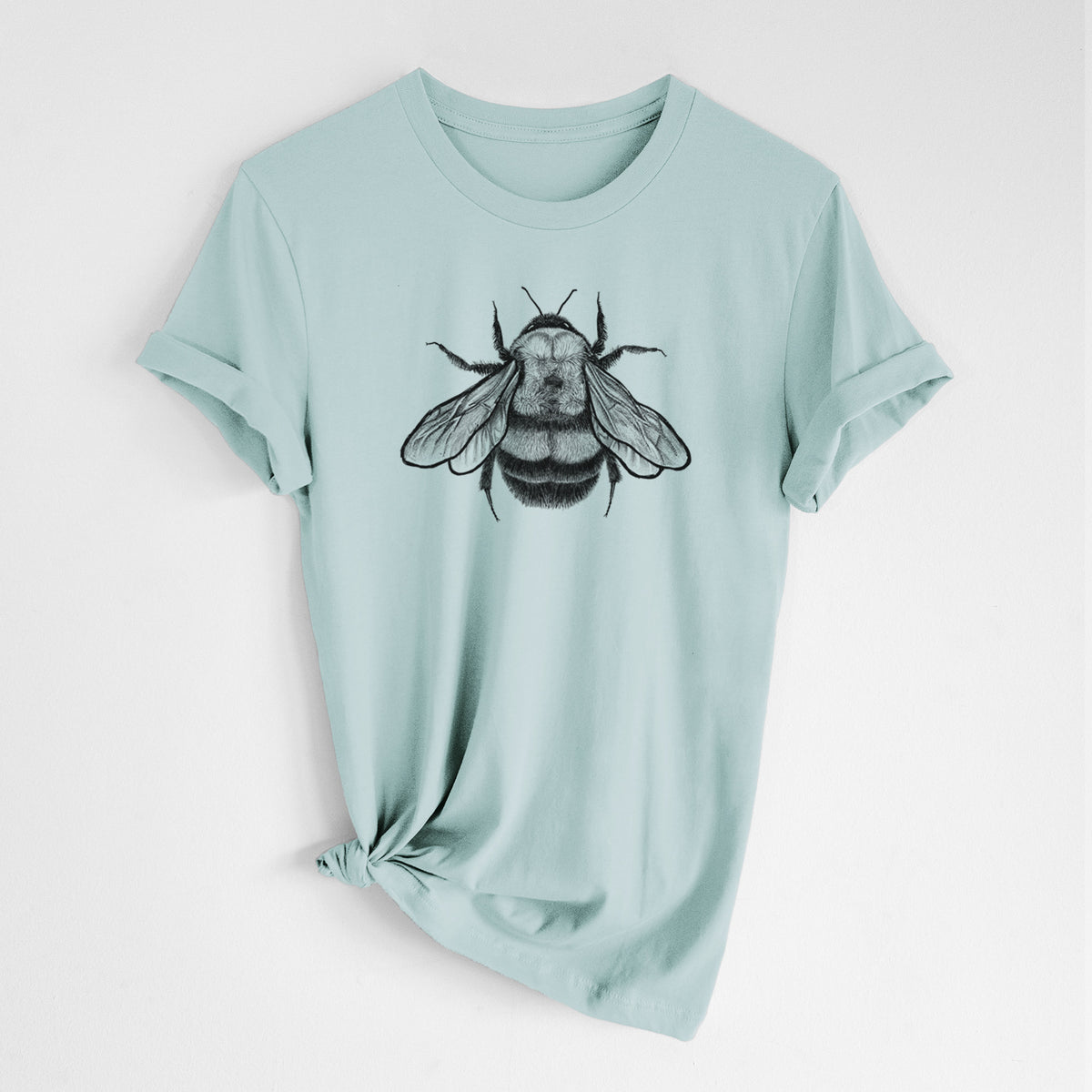 Dusty blue lightweight cotton t-shirt laid flat with the sleeves rolled, printed with a detailed black ink illustration of a rusty patched bumble bee with its wings spread, seen from above.