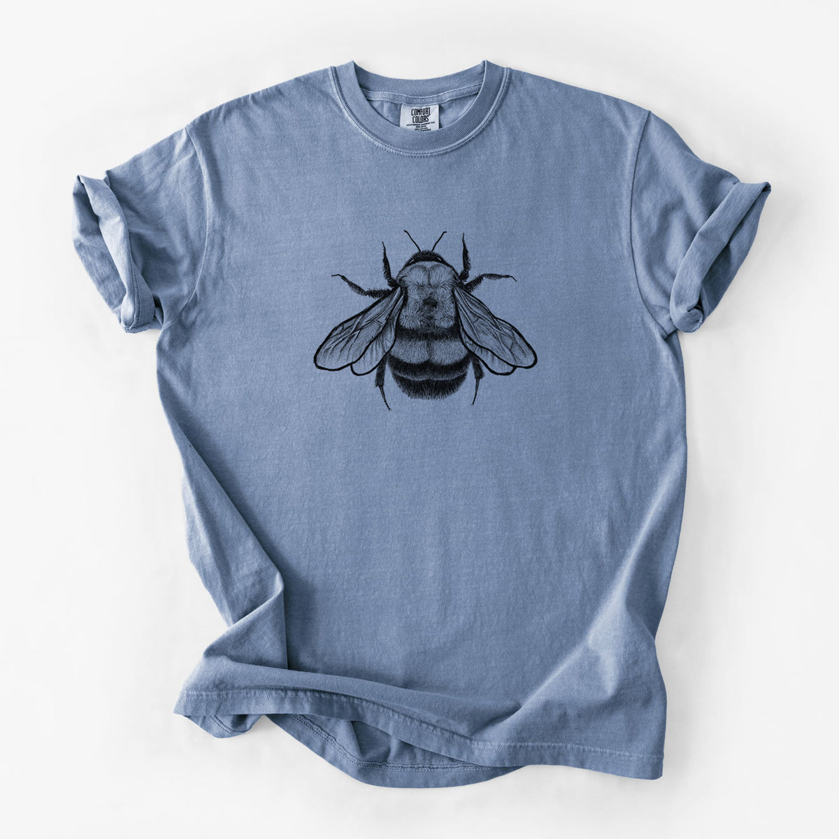 Blue jean Comfort Colors t-shirt laid flat, printed with a detailed black ink illustration of a rusty patched bumble bee with its wings spread, seen from above.