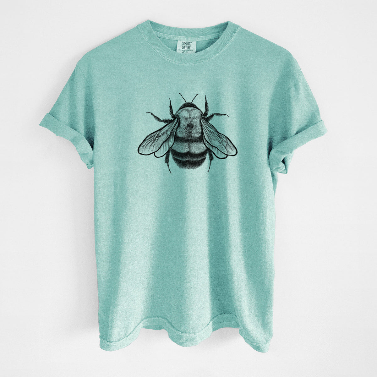 Chalky mint Comfort Colors t-shirt laid flat, printed with a detailed black ink illustration of a rusty patched bumble bee with its wings spread, seen from above.