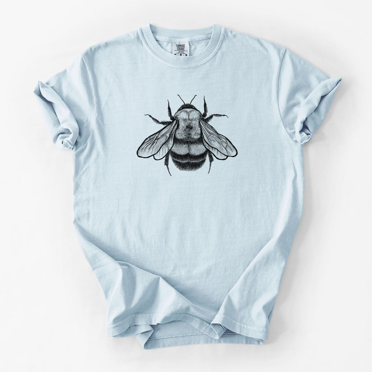 Chambray blue Comfort Colors t-shirt laid flat, printed with a detailed black ink illustration of a rusty patched bumble bee with its wings spread, seen from above.