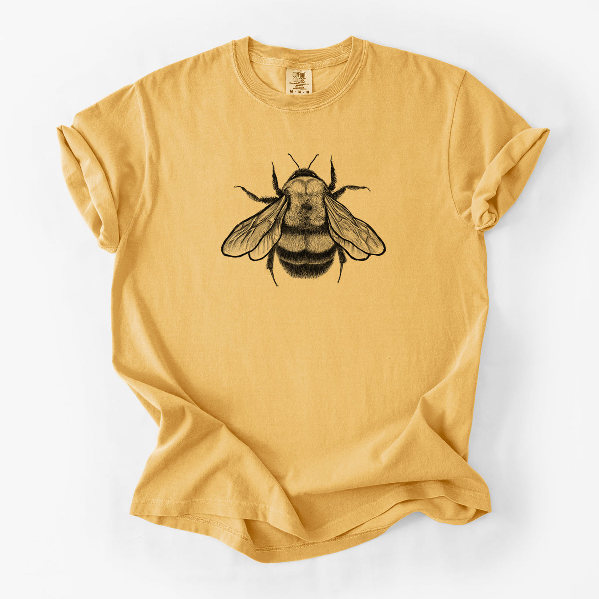 Golden wheat yellow Comfort Colors t-shirt laid flat, printed with a detailed black ink illustration of a rusty patched bumble bee with its wings spread, seen from above.