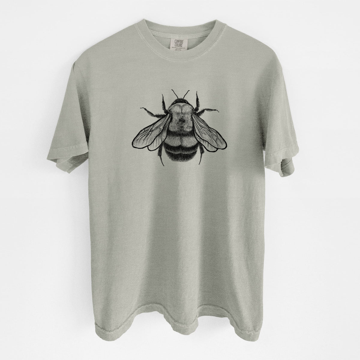 Sandstone beige Comfort Colors t-shirt laid flat, printed with a detailed black ink illustration of a rusty patched bumble bee with its wings spread, seen from above.