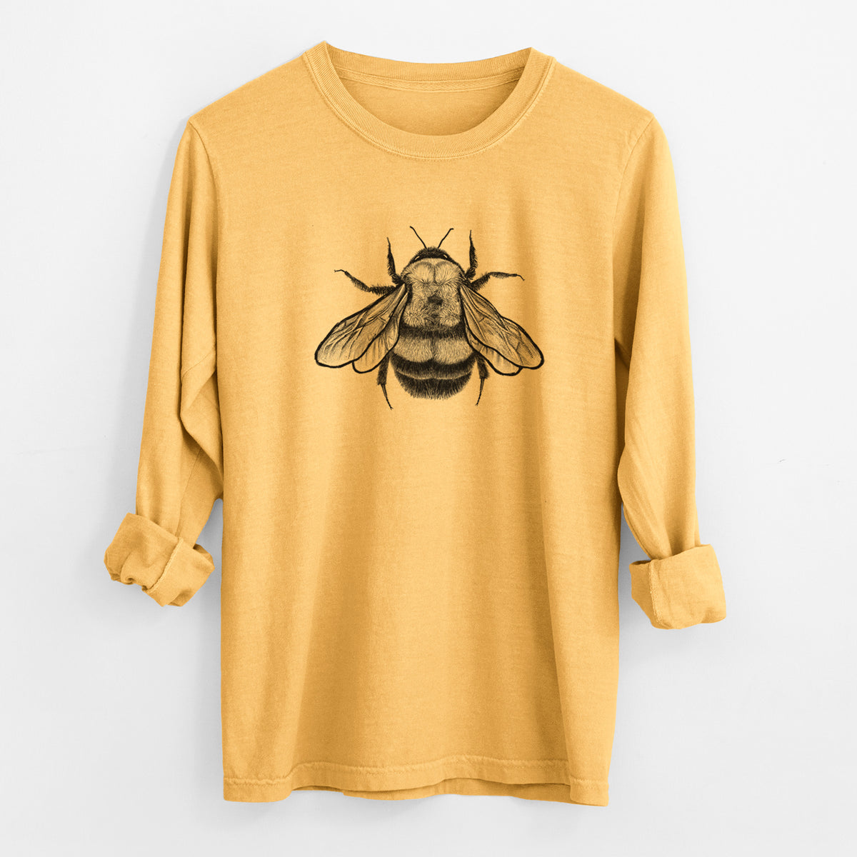Golden wheat yellow Comfort Colors long sleeve shirt laid flat with the cuffs rolled, printed with a detailed black ink illustration of a rusty patched bumble bee with its wings spread, seen from above.