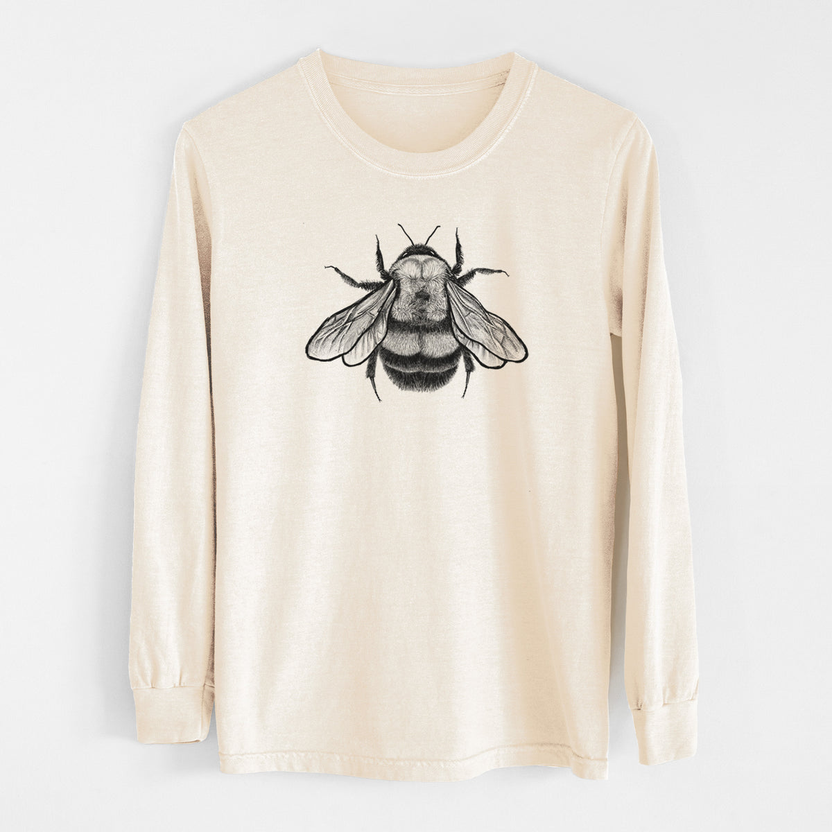 Ivory Comfort Colors long sleeve shirt laid flat, printed with a detailed black ink illustration of a rusty patched bumble bee with its wings spread, seen from above.
