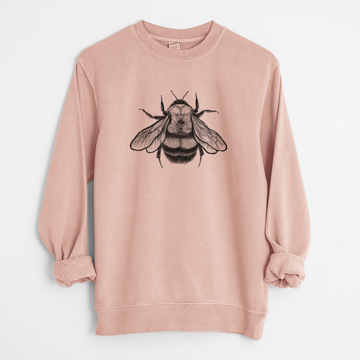 Dusty pink pigment dyed crewneck sweatshirt laid flat with the sleeves rolled, printed with a detailed black ink illustration of a rusty patched bumble bee with its wings spread, seen from above.