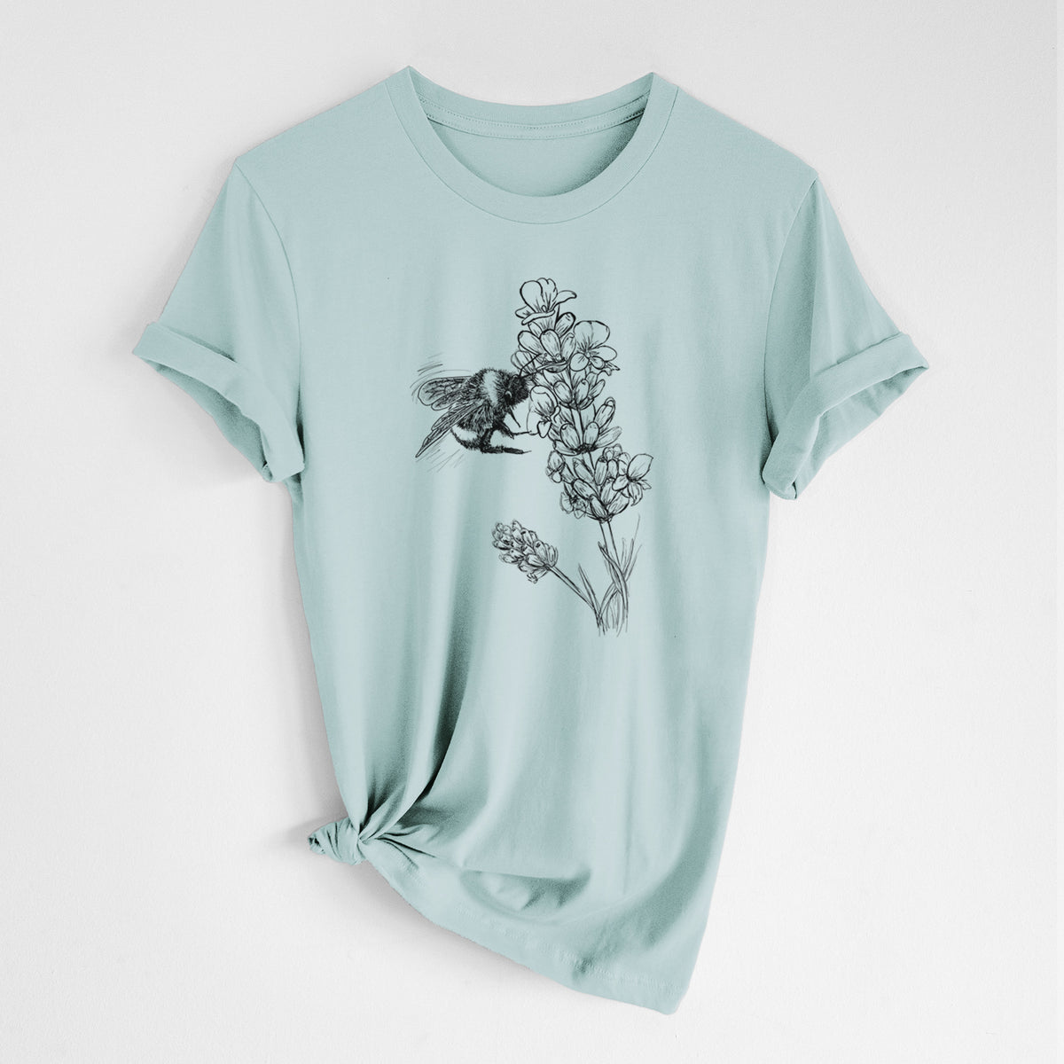 Dusty blue lightweight cotton t-shirt laid flat with the sleeves rolled, printed with a black ink illustration of a bumble bee visiting a sprig of lavender.