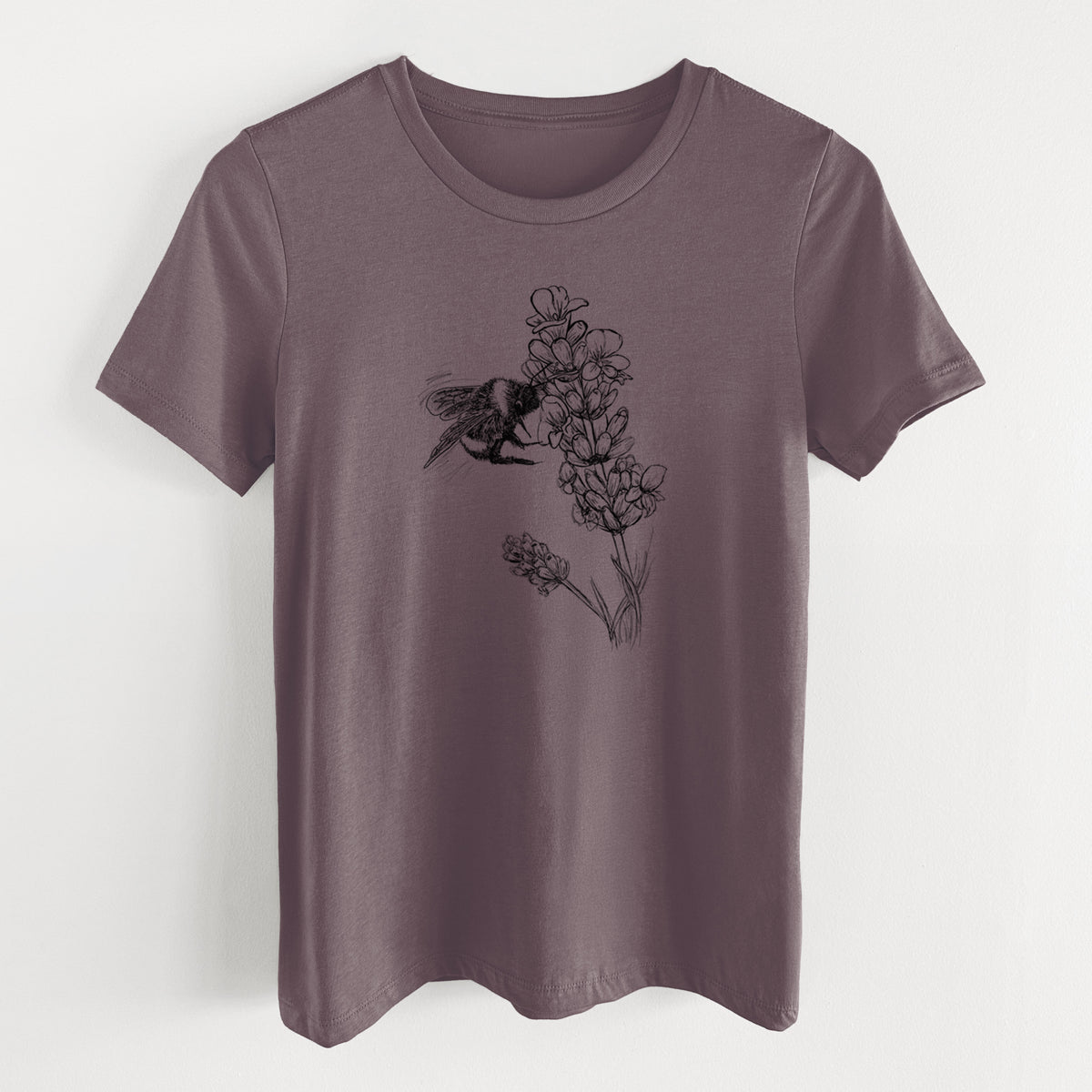 Purple storm women's relaxed fit cotton t-shirt laid flat, printed with a black ink illustration of a bumble bee visiting a sprig of lavender.
