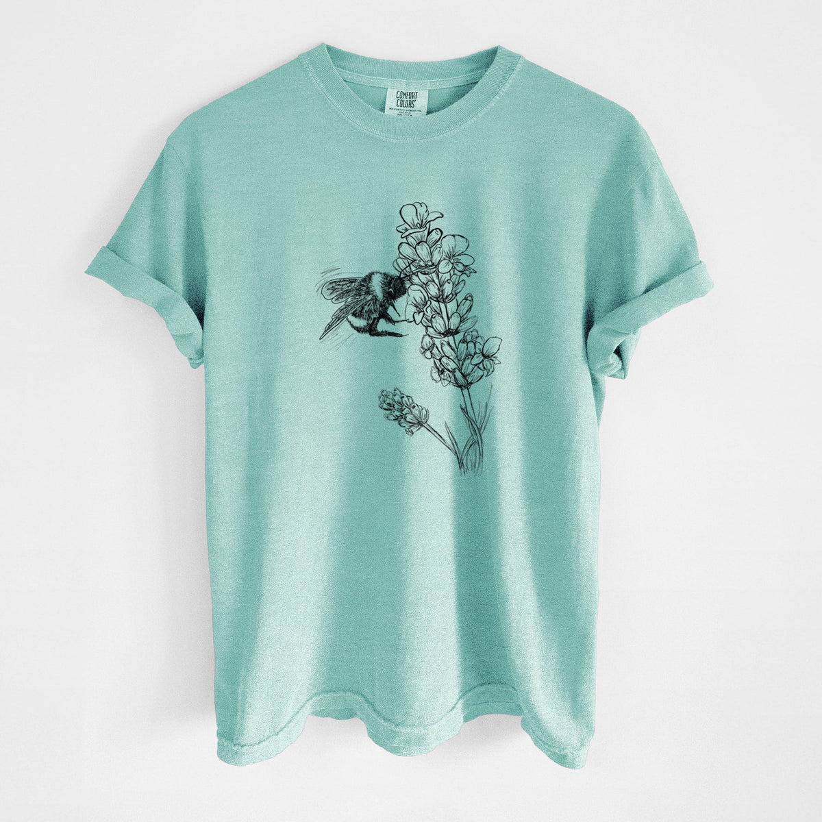 Chalky mint Comfort Colors t-shirt laid flat, printed with a black ink illustration of a bumble bee visiting a sprig of lavender.