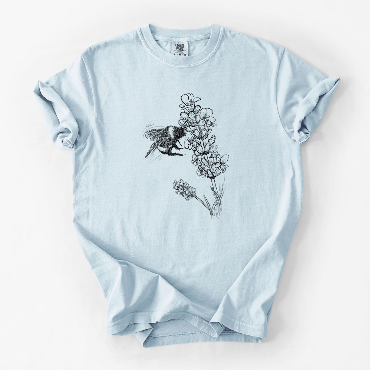 Chambray blue Comfort Colors t-shirt laid flat, printed with a black ink illustration of a bumble bee visiting a sprig of lavender.