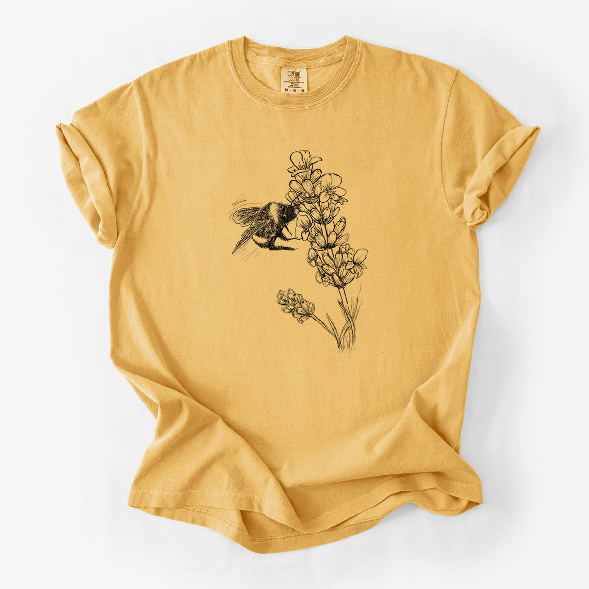 Golden wheat yellow Comfort Colors t-shirt laid flat, printed with a black ink illustration of a bumble bee visiting a sprig of lavender.