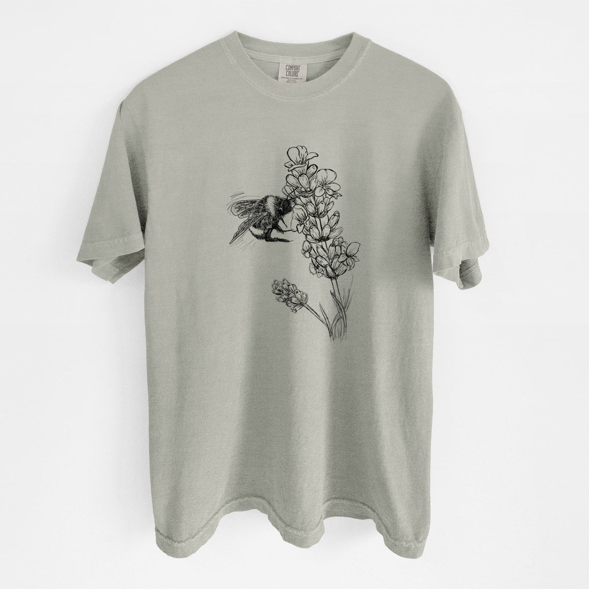 Sandstone beige Comfort Colors t-shirt laid flat, printed with a black ink illustration of a bumble bee visiting a sprig of lavender.