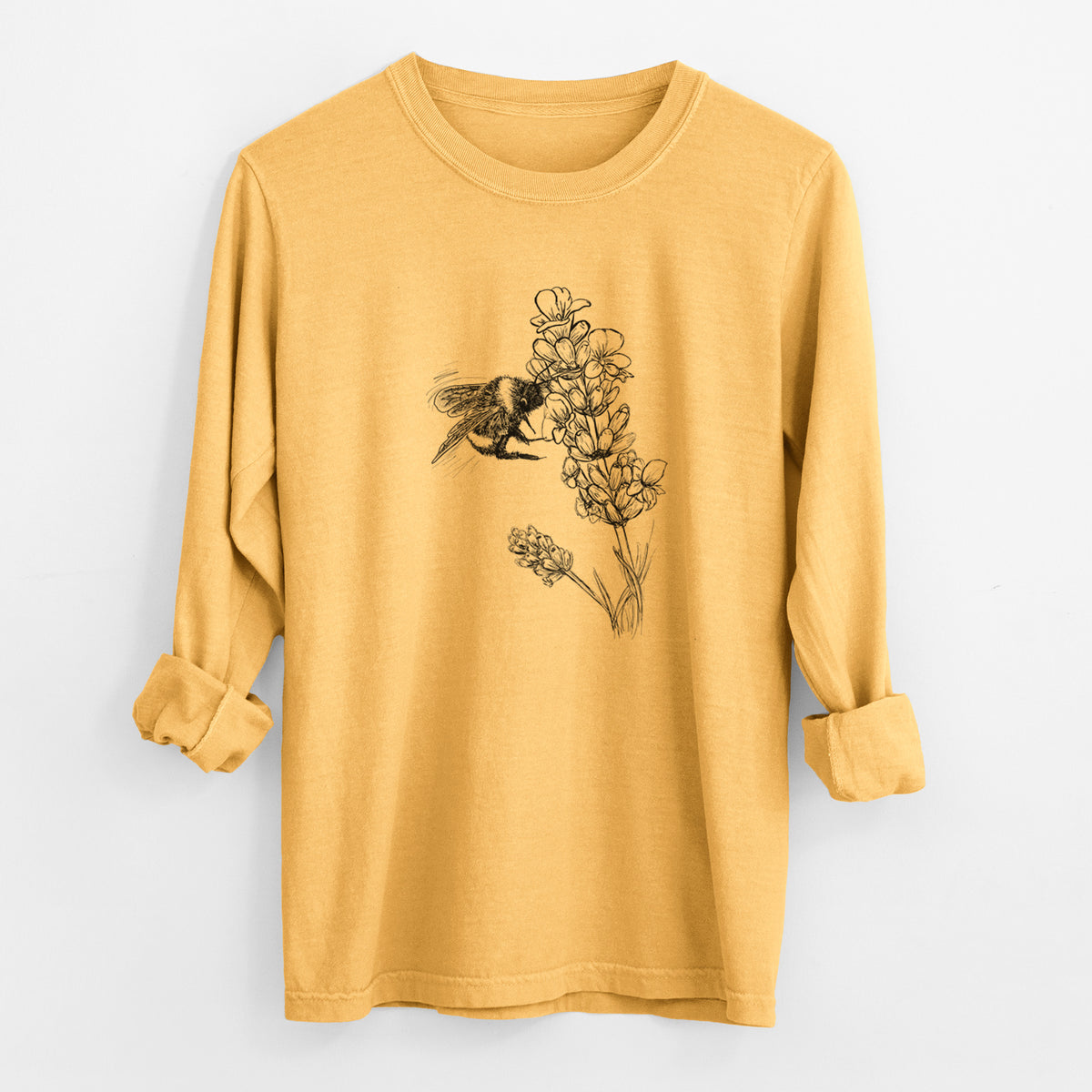 Golden wheat yellow Comfort Colors long sleeve shirt laid flat with the cuffs rolled, printed with a black ink illustration of a bumble bee visiting a sprig of lavender.