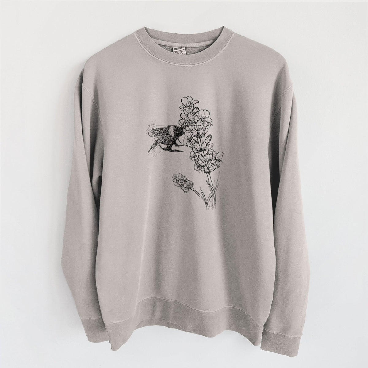 Cement grey pigment dyed crewneck sweatshirt laid flat, printed with a black ink illustration of a bumble bee visiting a sprig of lavender.