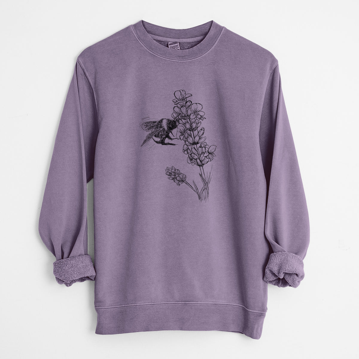 Plum purple pigment dyed crewneck sweatshirt laid flat with the sleeves rolled, printed with a black ink illustration of a bumble bee visiting a sprig of lavender.