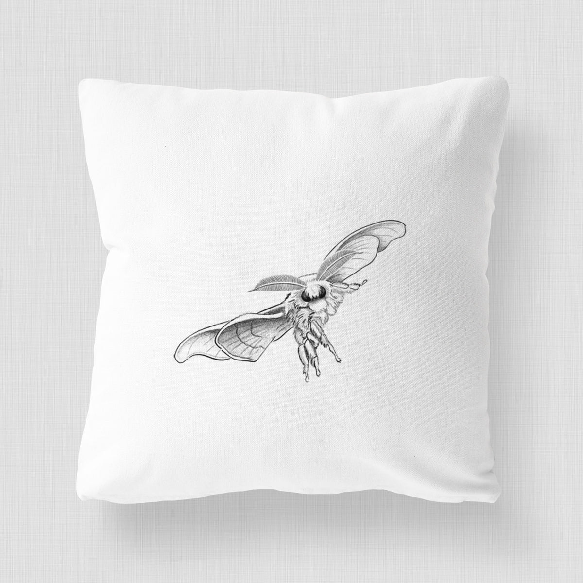 White pillow cover printed with a black ink illustration of a silk moth with its wings spread.