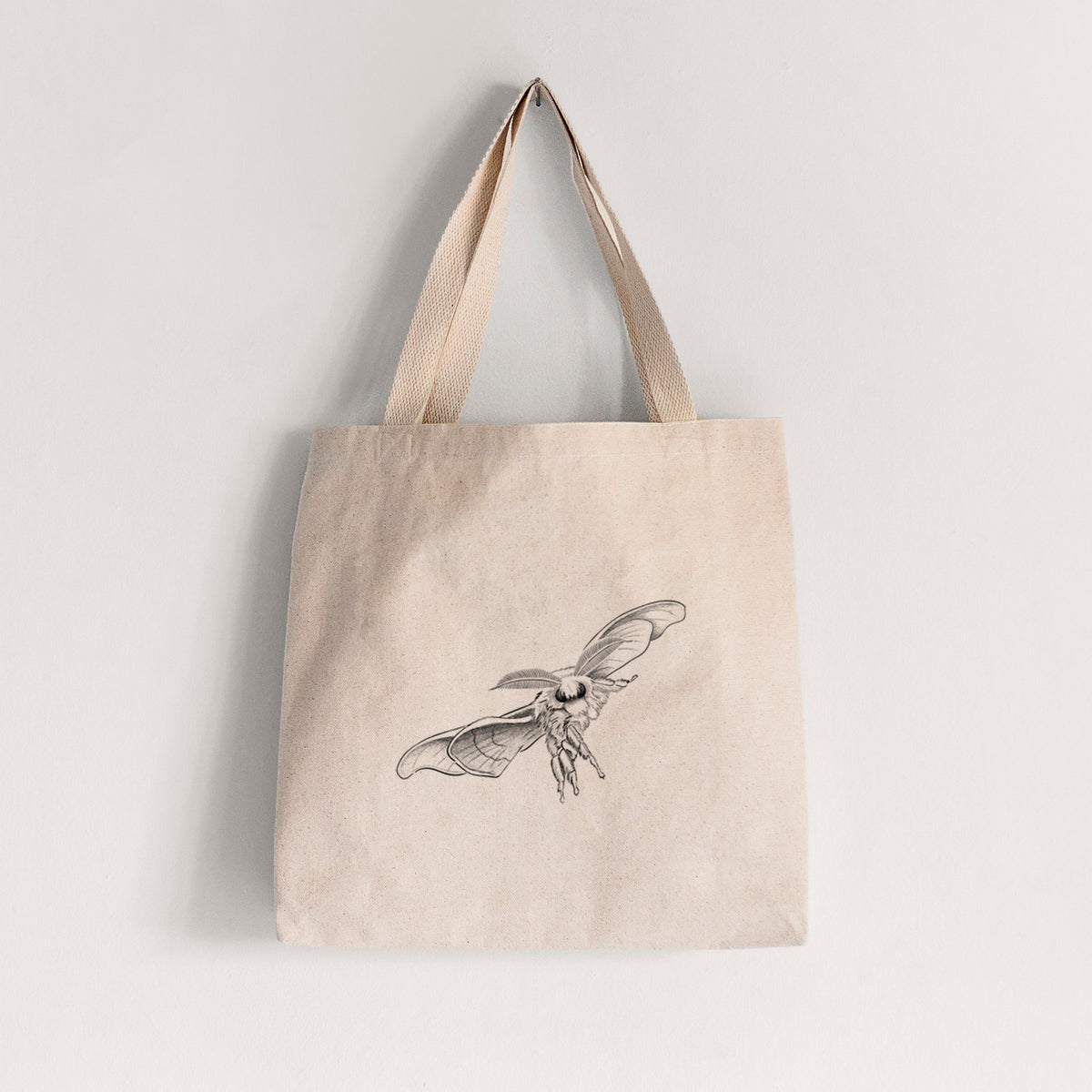Natural canvas tote bag printed with a black ink illustration of a silk moth with its wings spread.