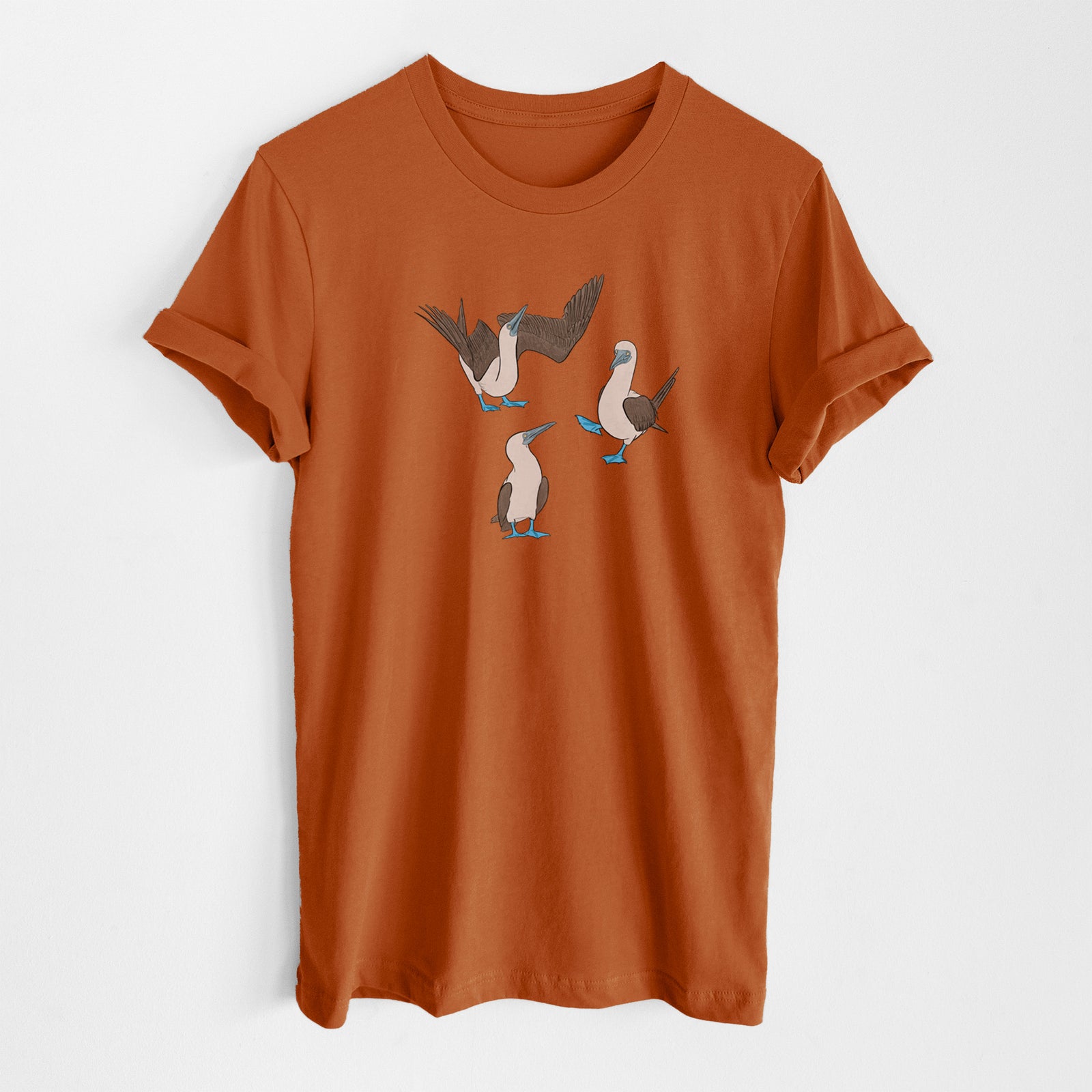 Autumn lightweight cotton t-shirt laid flat, printed with a full-color illustration of three blue-footed boobies, one with its wings spread.