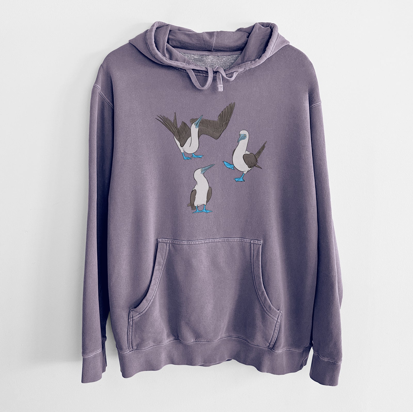 Plum purple pigment dyed hoodie laid flat, printed with a full-color illustration of three blue-footed boobies, one with its wings spread.