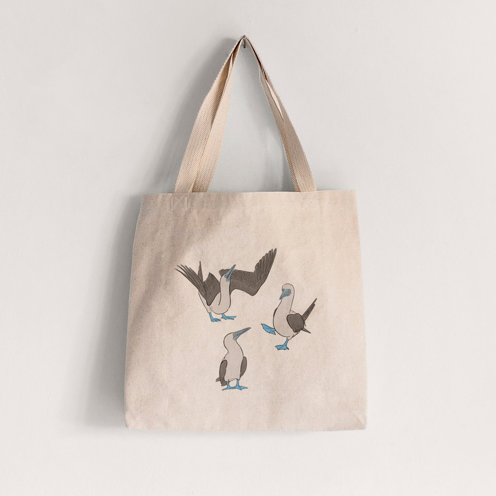 Natural canvas tote bag printed with a full-color illustration of three blue-footed boobies, one with its wings spread.