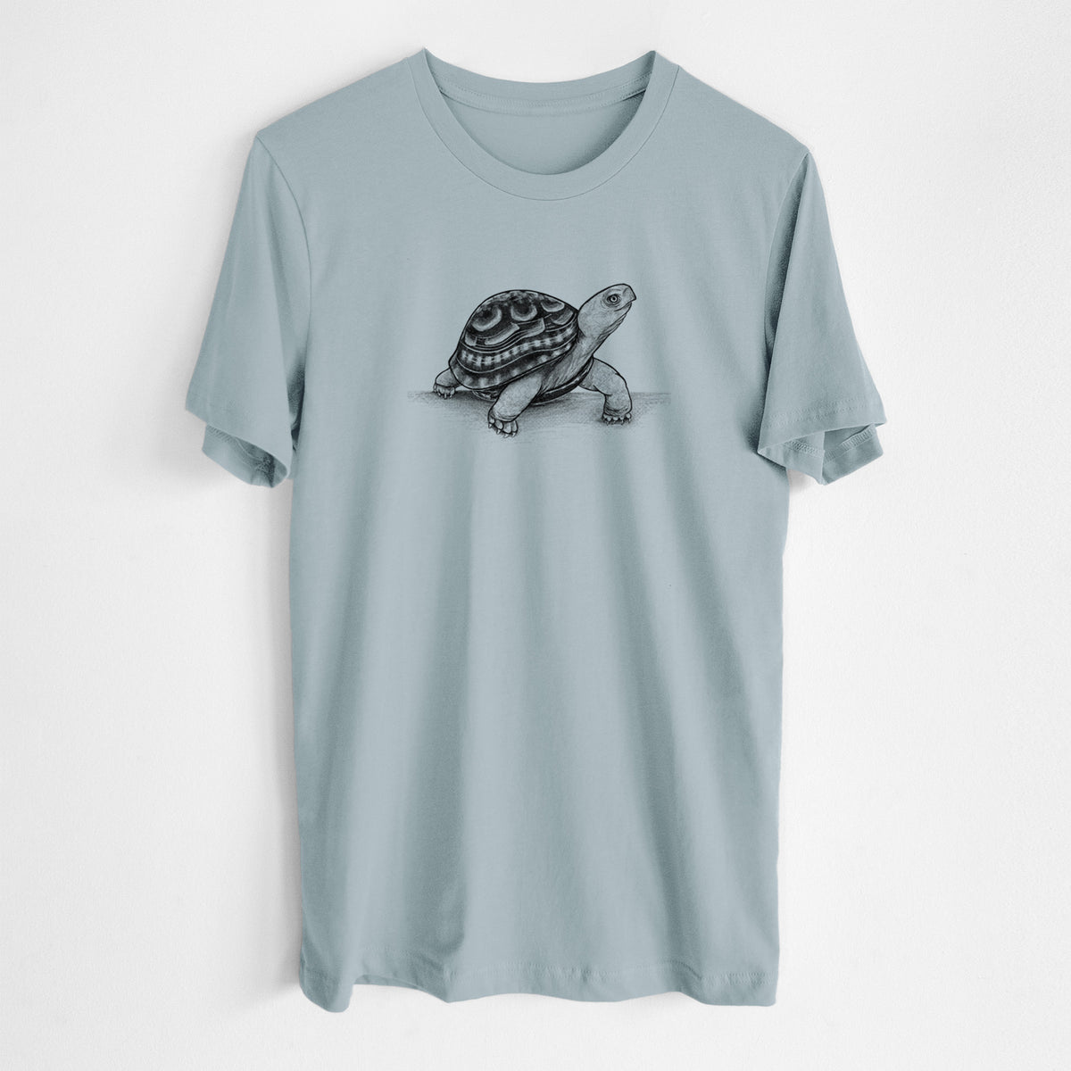 Vintage denim lightweight cotton t-shirt laid flat, printed with a detailed black ink illustration of an eastern box turtle walking.