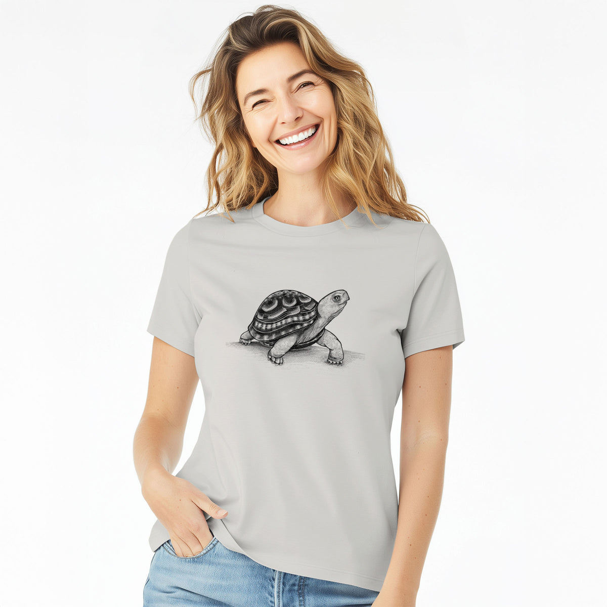 Woman wearing a lunar grey women's relaxed fit cotton t-shirt printed with a detailed black ink illustration of an eastern box turtle walking.