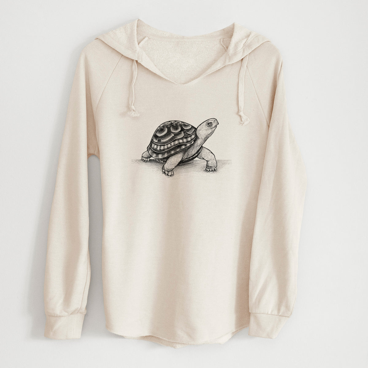 Bone cream women's Cali Wave hooded sweatshirt laid flat, printed with a detailed black ink illustration of an eastern box turtle walking.