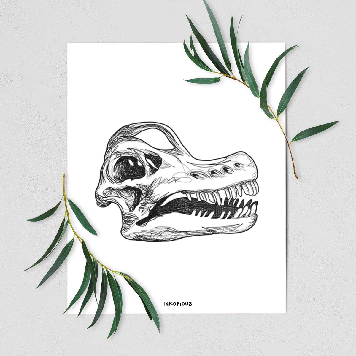 Art print of a detailed black ink illustration of a Brachiosaurus skull, shown with eucalyptus leaves.
