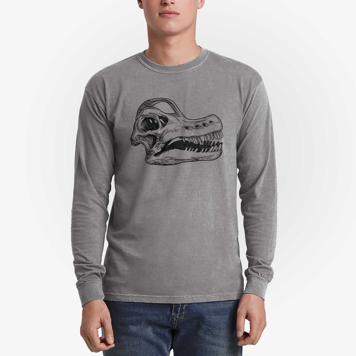 Man wearing a grey Comfort Colors long sleeve shirt printed with a detailed black ink illustration of a Brachiosaurus skull.