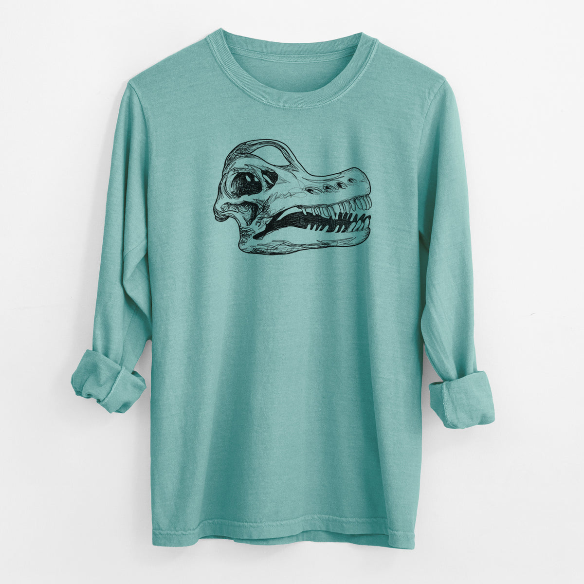 Reef green Comfort Colors long sleeve shirt laid flat with the cuffs rolled, printed with a detailed black ink illustration of a Brachiosaurus skull.