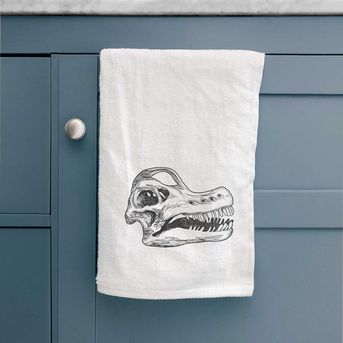 White hand towel printed with a detailed black ink illustration of a Brachiosaurus skull.