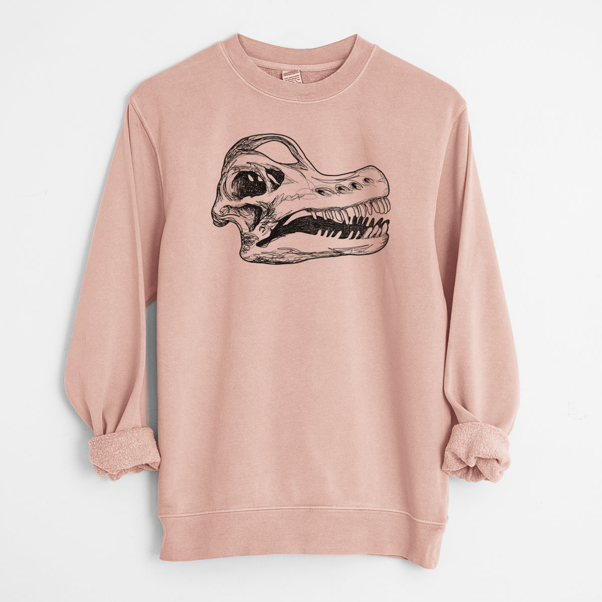 Dusty pink pigment dyed crewneck sweatshirt laid flat with the sleeves rolled, printed with a detailed black ink illustration of a Brachiosaurus skull.