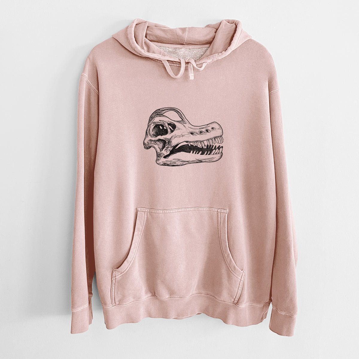 Dusty pink pigment dyed hoodie laid flat, printed with a detailed black ink illustration of a Brachiosaurus skull.
