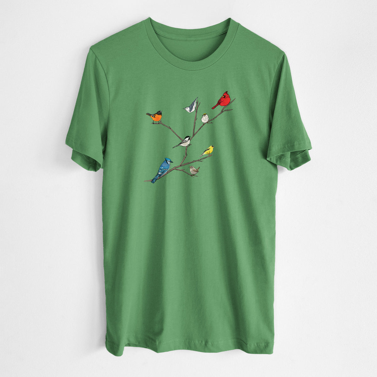 Leaf green lightweight cotton t-shirt laid flat, printed with a full-color illustration of backyard birds, including a cardinal, blue jay, goldfinch and robin, perched on bare branches.