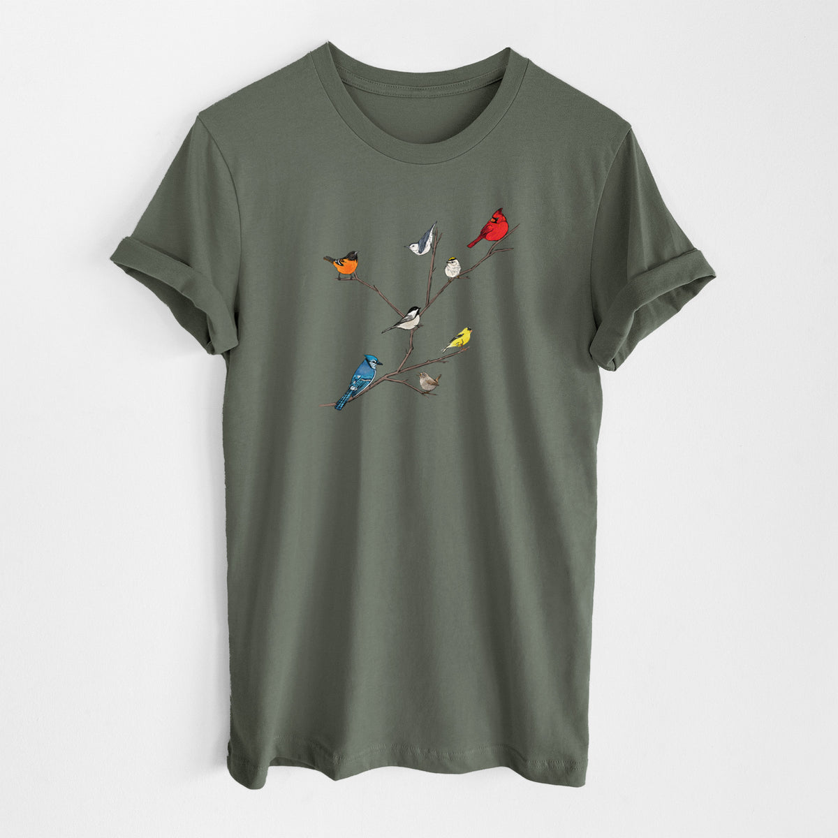 Military green lightweight cotton t-shirt laid flat, printed with a full-color illustration of backyard birds, including a cardinal, blue jay, goldfinch and robin, perched on bare branches.