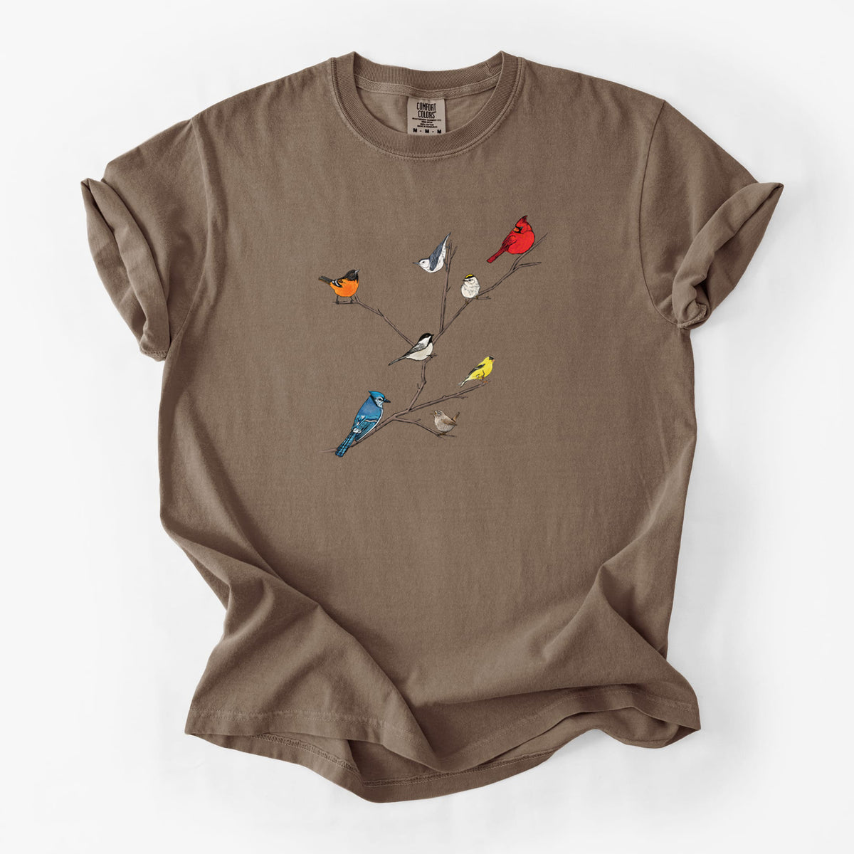 Espresso brown Comfort Colors t-shirt laid flat, printed with a full-color illustration of backyard birds, including a cardinal, blue jay, goldfinch and robin, perched on bare branches.