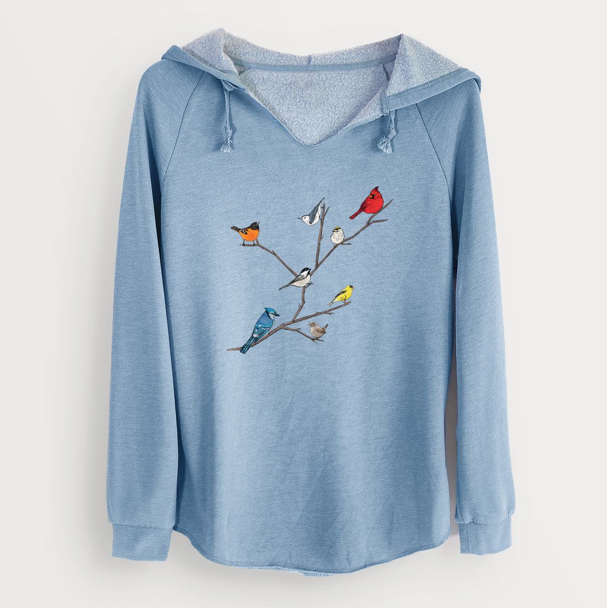 Misty blue women's Cali Wave hooded sweatshirt laid flat, printed with a full-color illustration of backyard birds, including a cardinal, blue jay, goldfinch and robin, perched on bare branches.